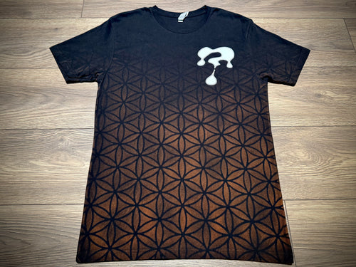Flat lay—hand-dyed sacred-geometry fade tee with speaker-stack print